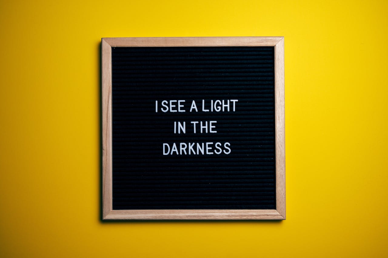 heros-img Black letterboard with a motivational quote on a vibrant yellow background.